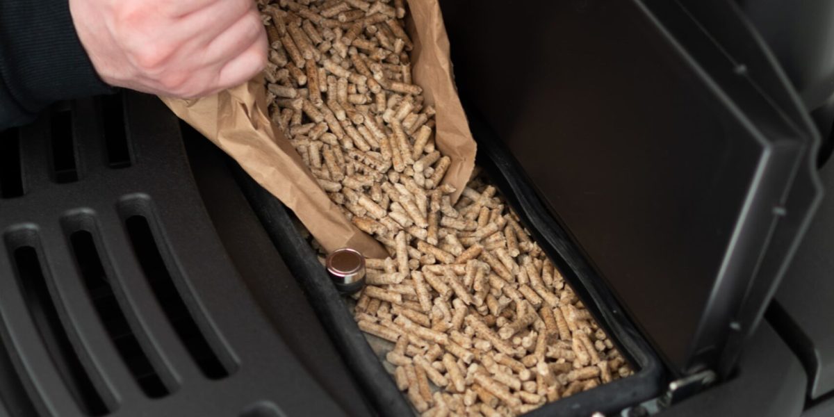 man-loading-pellet-stove-with-granule-bag (1)